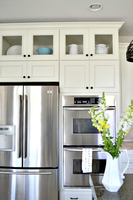 Kitchen cabinets with glass store doors on top