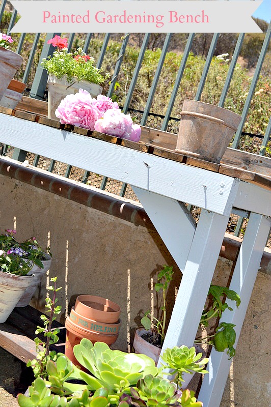 Painted garden bench with dark stain and blue paint.