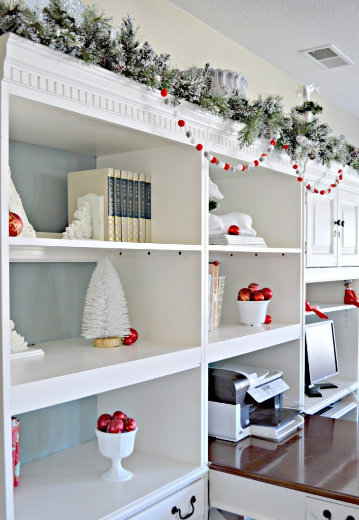 Office Bookshelves decorated for Christmas, love the white and red together!