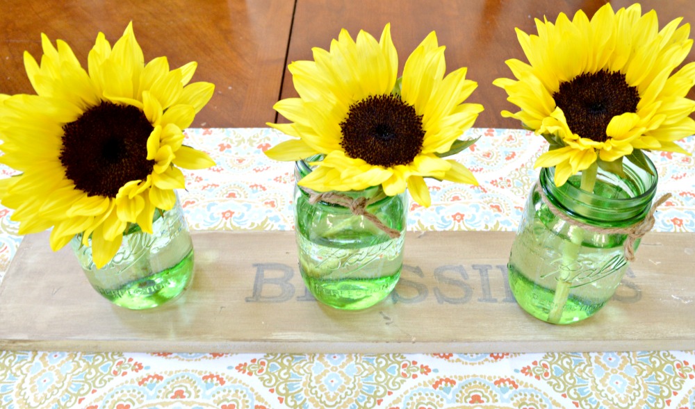add sunflowers into mason jars for a easy 10 minute fall decor