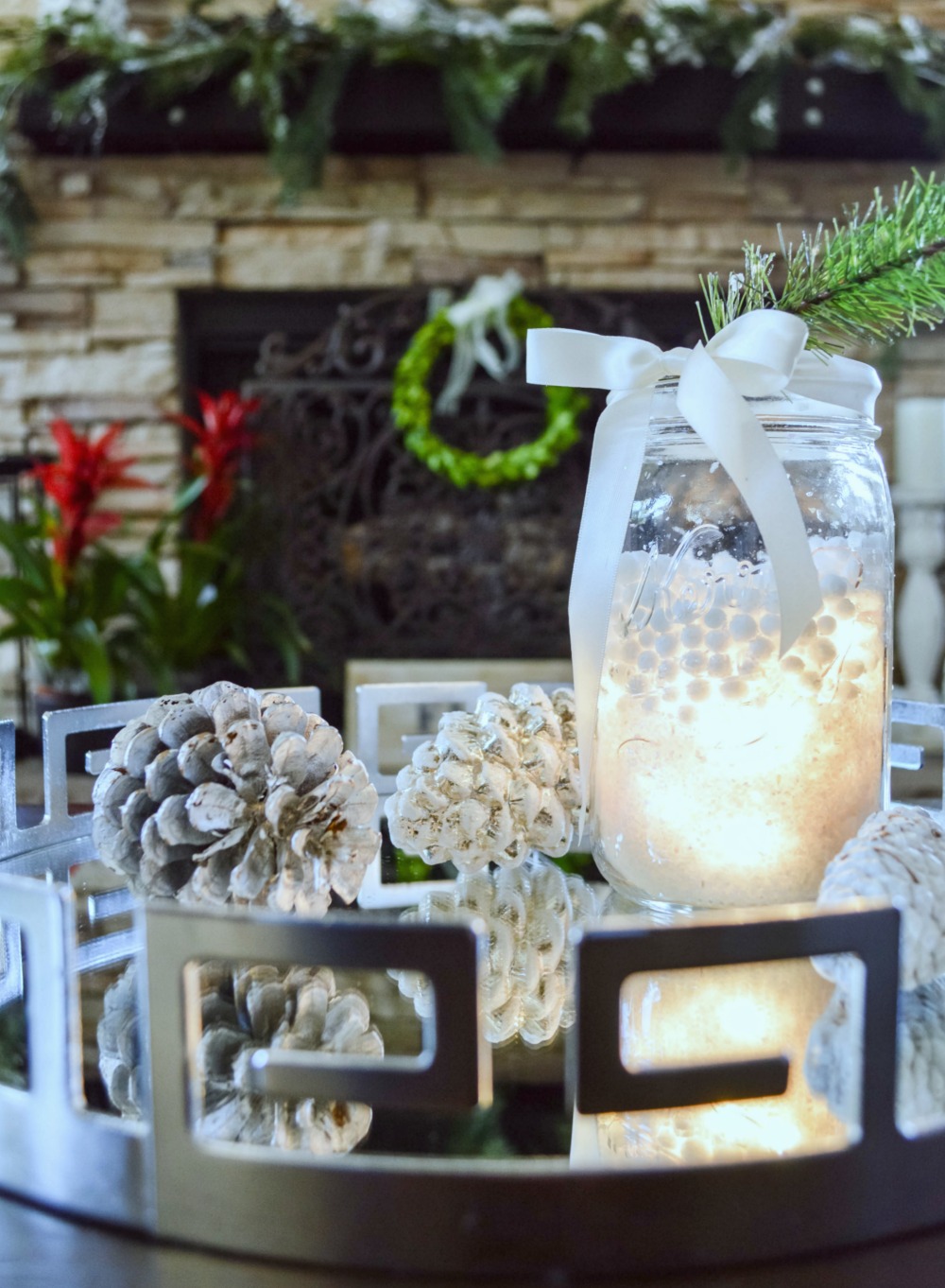 LED mini string of lights tucked into fake snow in a mason jar, so pretty at night