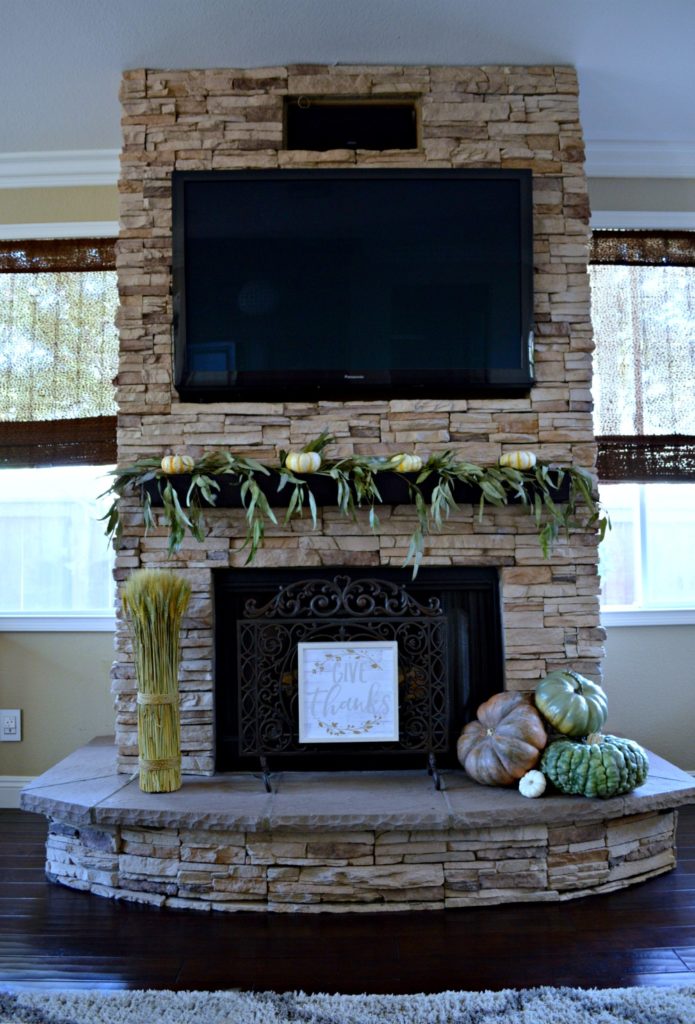 stacked stone brick fireplace decorated for fall