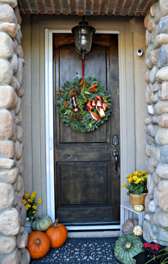 gorgeous fall wreath will magnolia leaves and lantern, so pretty!