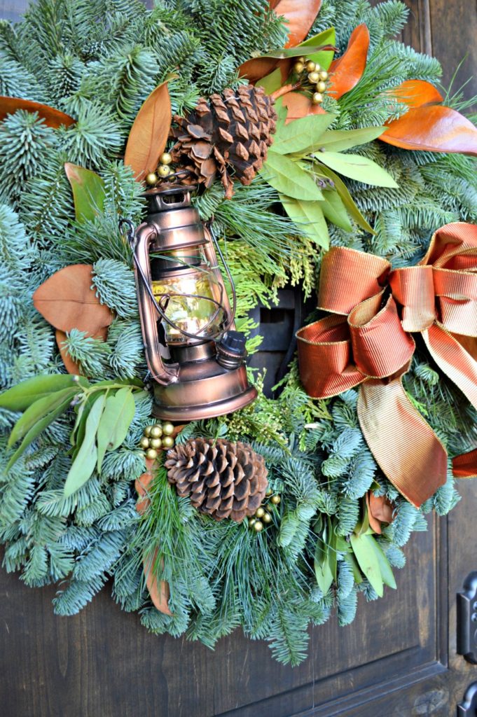 gorgeous fall wreath will magnolia leaves and lantern, so pretty!