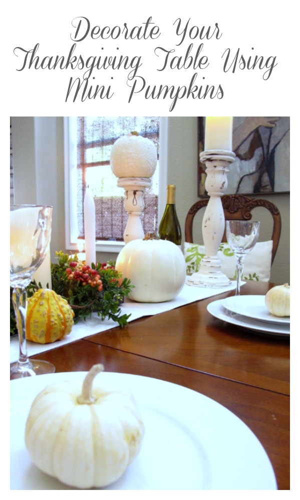 line up mini pumpkins down the center of the table with candles, flowers and gourds for a beautiful thanksgiving display