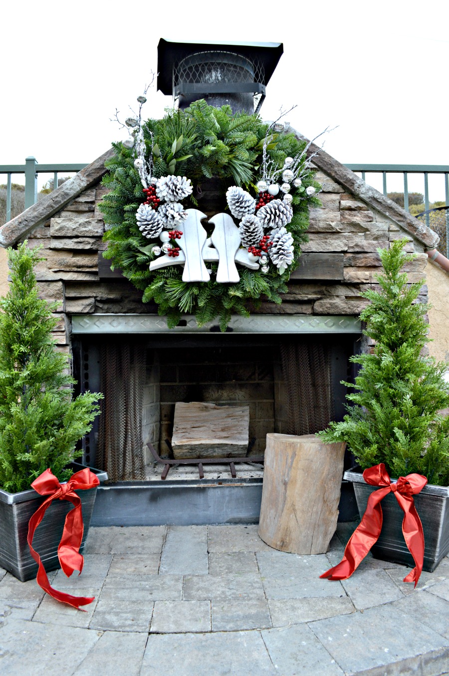 Gorgeous stone fireplace decorated for Christmas with Lynch creek farms wreath
