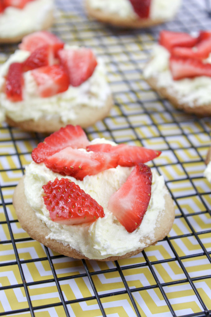 *Directions* - In a large bowl, combine the frozen whipped topping and lemon curd until it's completely mixed. - Use a spoon to scoop a small amount on top of the sugar cookies and spread it so the top is completely covered. - Top with chopped strawberries. - Serve immediately or chill in fridge until ready to serve.