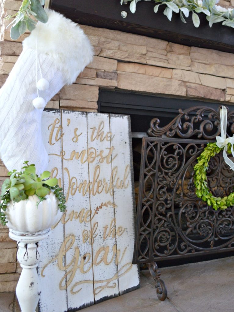 Christmas mantel decorated in white and green