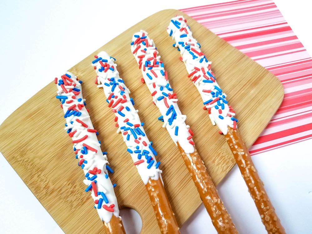 These Firecracker Candy Coated Pretzels  are one of my favorite easy desserts to make for any patriotic Holiday.  Not only do they have a fun and festive look, they taste great too and the kids will love helping you make them!