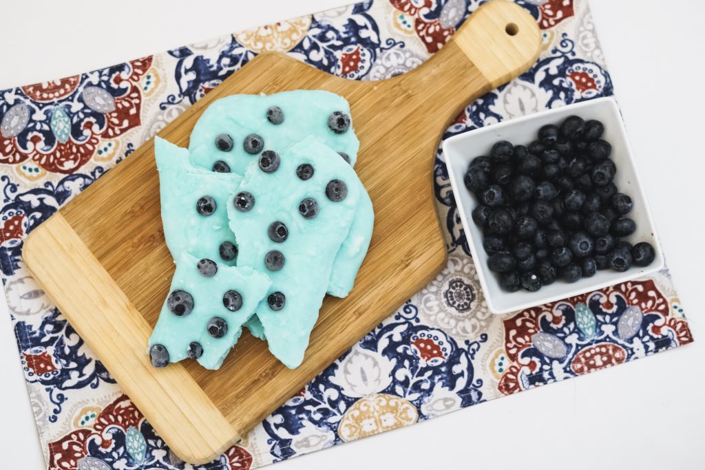 this Make Ahead Blueberry Greek Yogurt Bark is a 2-ingredient treat you can take with you or munch on when you need a quick snack! Full of protein and probiotics!