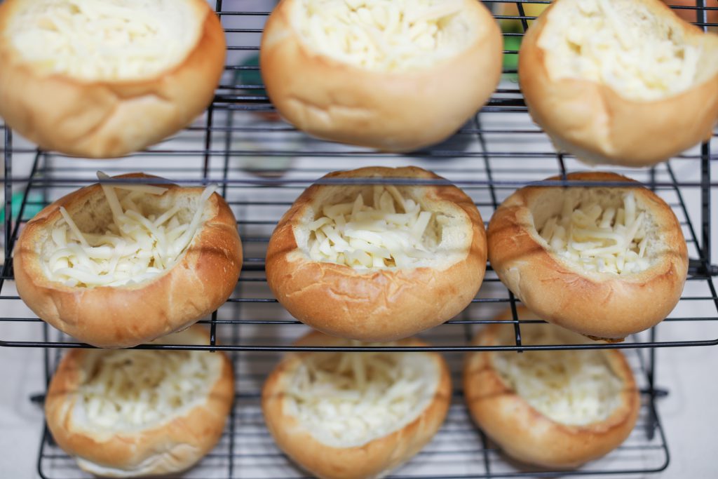 This is the most delicious french onion soup recipe in a bread bowl. French Onion Soup is the perfect comfort food on a cold winters night, everyone will know how much love you put into this meal. Caramelized onions, beef broth, melted gruyere cheese come together to form the most comforting, delicious bowl of French Onion Soup you will ever eat! 