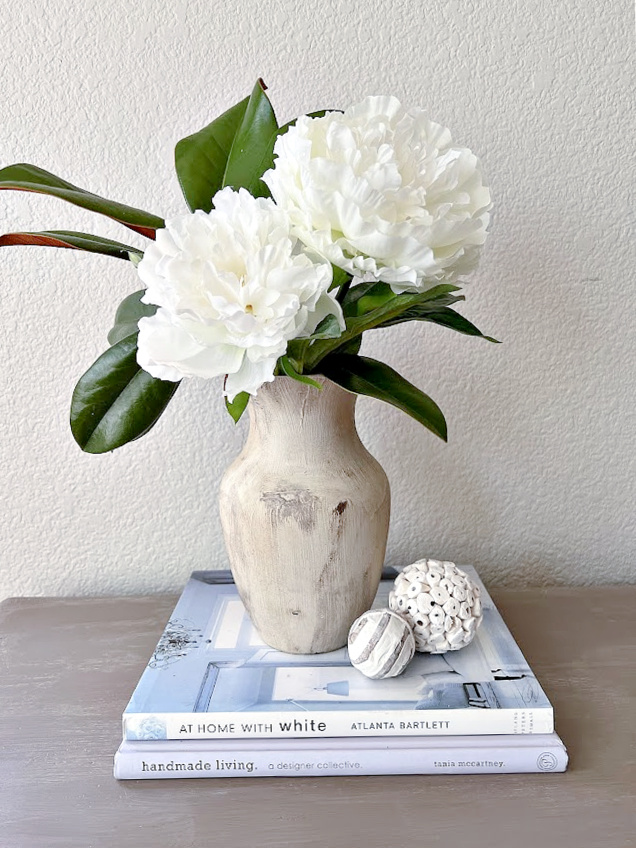 vase on top of books with flowers
