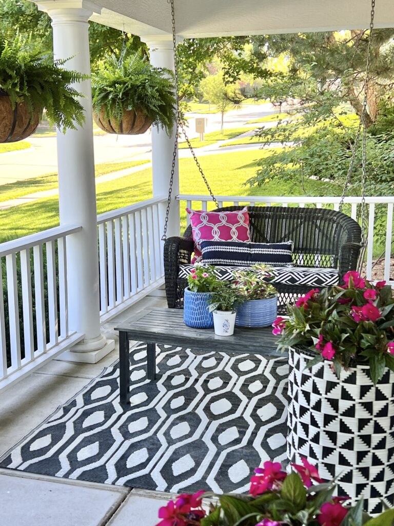 https://myuncommonsliceofsuburbia.com/wp-content/uploads/2023/07/Plants-and-flowers-on-the-covered-front-porch-Sonata-Home-Design-768x1024-1.jpg